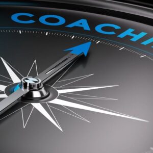 Compass needle pointing towards the word 'COACHING'.